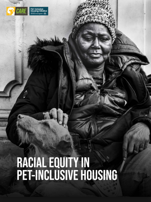 A gray scale photo features a woman sitting outside with her dog.